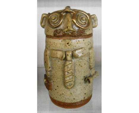 An Andrew Haig studio pottery lidded jar in the form of a stylised gentleman with briefcase and newspaper