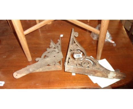 A pair of large cast iron shelf bracket with decorative scrolling - sold with a smaller similar pair