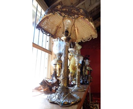 A modern Art Nouveau French salon style brass table lamp and shade, the central pillar with decorative lilypad design with pi