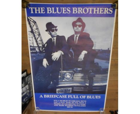 Three rolled posters:  comprising Blues Brothers 'A Briefcase Full of Blues', Pink Floyd Wembley concert and Iron Maiden - in