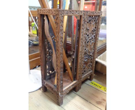 An Indian carved hard wood stick stand with pierced grapevine panels and replacement base - originally fold-up