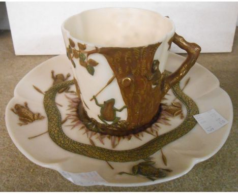 A 19th Century Royal Worcester porcelain cup and saucer decorated in the Aesthetic Movement style depicting frogs around a tr