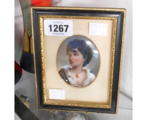 A 19th Century framed Berlin porcelain oval portrait plaque depicting a young man in later Hogarth frame