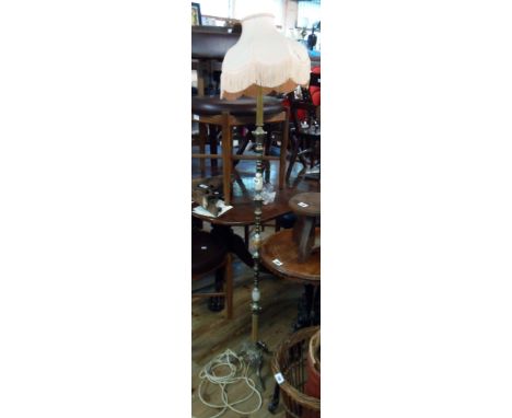 A late 20th Century brassed metal and onyx decorative standard lamp with tassel shade