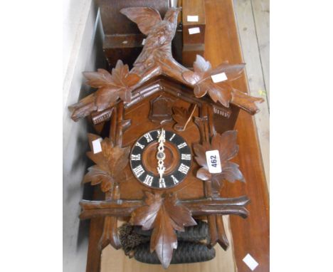 A vintage polished wood cased cuckoo wall clock with twin cast metal pinecone pattern weights - pendulum missing