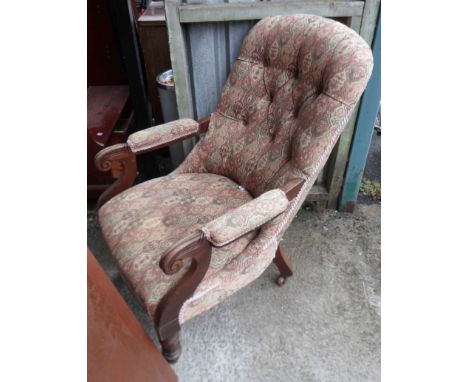 A Victorian stained wood framed scroll armchair with button back floral tapestry upholstery, set on turned and fluted front l