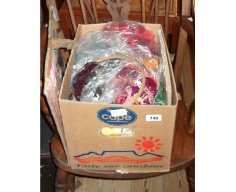 A box containing a quantity of tapestry wools, tapestry ring, etc.