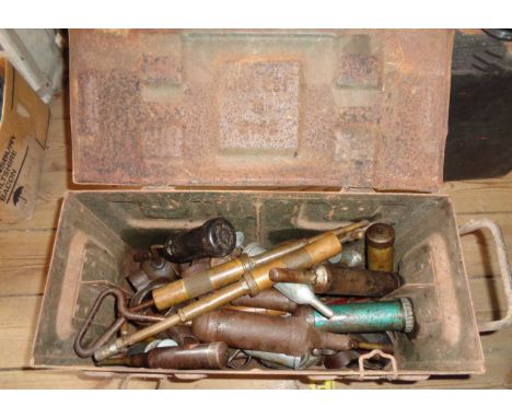 An old metal toolbox containing a quantity of assorted tools including grease guns, etc.