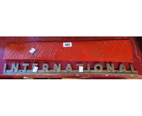 An old chrome plated International Tractor sign - sold with an old pressed tin David Brown Horn-Draulic tractor sign