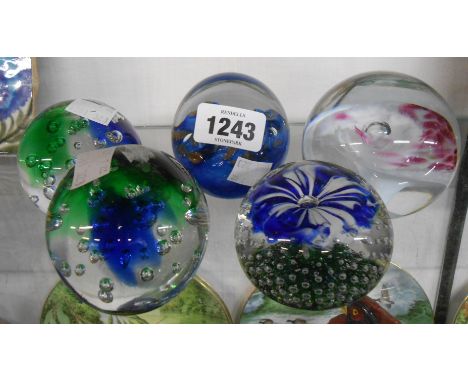 Five glass paperweights including internal enamel and controlled bubble examples