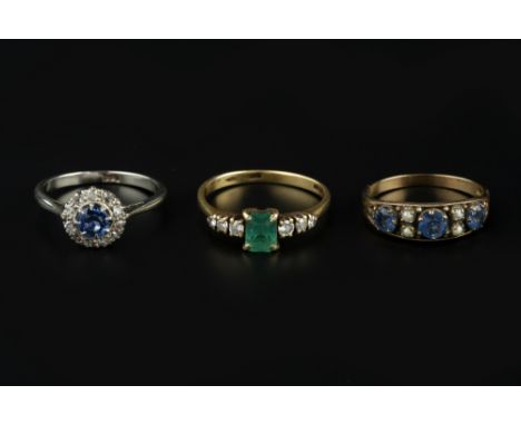 THREE GEM SET DRESS RINGS, comprising an emerald and diamond seven stone ring, 18ct gold mounted, a sapphire and half pearl h