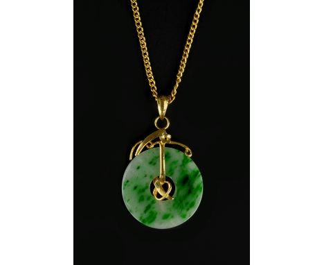 A JADE ANNULAR PENDANT, the circular jade panel suspended from a wirework mount with flowerhead accents, on a curb-link chain