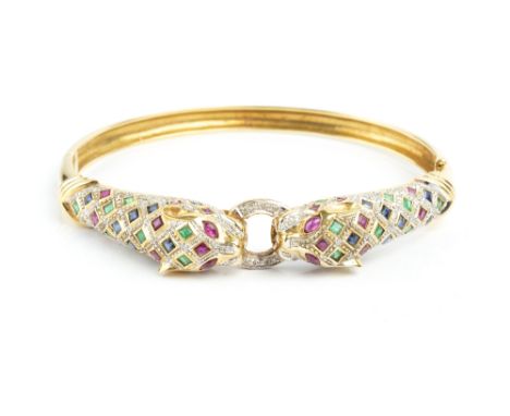 A VARI GEM-SET BANGLE, of hinged oval form, modelled as two leopard's heads enclosing a central hoop, set throughout with squ