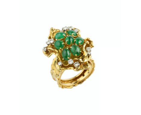 AN EMERALD AND DIAMOND DRESS RING BY GEORGE WEIL, designed as a tiered abstract flowerhead, centred with a cluster of oval ca