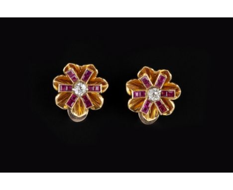 A PAIR OF RUBY AND DIAMOND EAR CLIPS, circa 1940, each stylised flowerhead panel centred with an old brilliant-cut diamond an