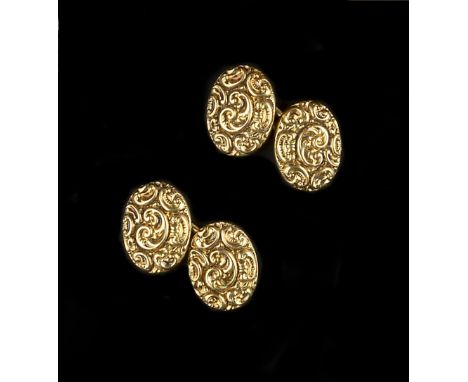 A COLLECTION OF CUFFLINKS AND DRESS STUDS, comprising a pair of oval panel cufflinks, profusely decorated with scrolls, on ba
