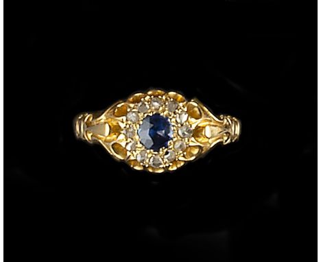 A SAPPHIRE AND DIAMOND CLUSTER RING, the circular mixed-cut sapphire bordered by lasque-cut diamonds, gold mounted, (hallmark