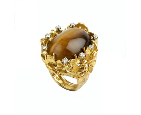 A TIGER'S EYE AND DIAMOND DRESS RING BY GEORGE WEIL, circa 1970-75, the oval cabochon tiger's eye claw set to a tapered mount