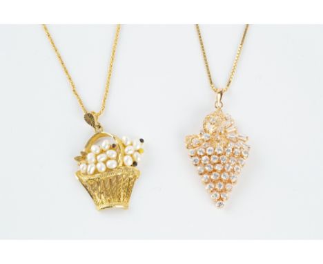 TWO PENDANT NECKLACES, the first modelled as a basket of flowers, with a cluster of freshwater pearls and enamel accents, on 