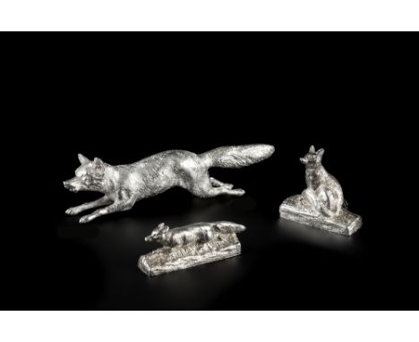 A SILVER MODEL of a running fox, maker's mark indistinct, London, 15.5cm long, 4 oz; and two silver menu holders, one modelle
