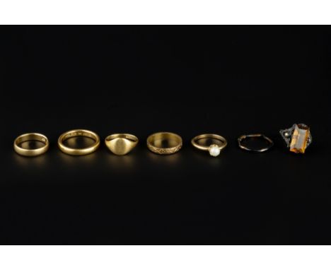 A COLLECTION OF RINGS, comprising a 22ct gold wedding band, an engraved 18ct gold wedding band, a further 18ct gold wedding b