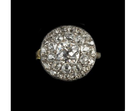 A 19TH CENTURY DIAMOND PANEL RING, the circular panel centred with a cushion-shaped old-cut diamond, bordered by two rows of 