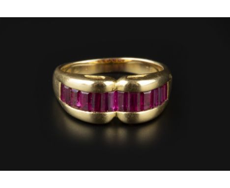 A RUBY HALF HOOP RING BY TIFFANY &amp; CO, of Odeonesque design, the line of rectangular step-cut rubies in shaped channel se