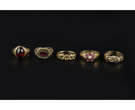 A COLLECTION OF DRESS RINGS, comprising a garnet single stone ring, with pierced and engraved foliate shoulders, a five stone