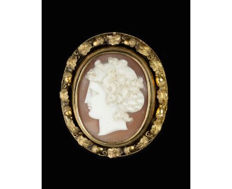 A VICTORIAN OVAL SHELL CAMEO BROOCH, carved to depict a classical female portrait in profile, with swivel glazed verso, borde
