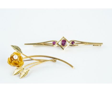 TWO GEM SET BROOCHES, comprising a ruby three stone bar brooch, the oval mixed-cut rubies in collet settings, yellow precious