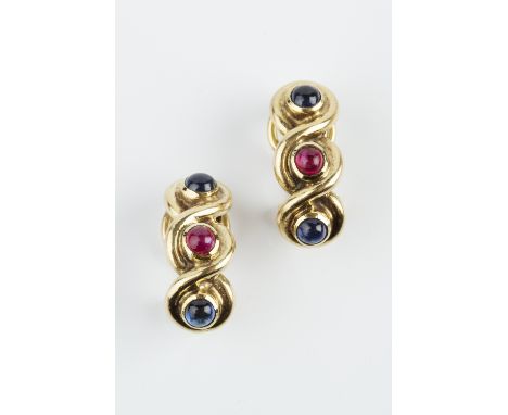 A PAIR OF RUBY AND SAPPHIRE SET EAR CLIPS, of half hoop twist design, each with a trio of cabochon sapphires and rubies in co