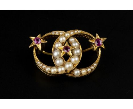 A VICTORIAN RUBY AND HALF PEARL PANEL BROOCH, modelled as two entwined crescent moons of graduated half pearls, spaced by a t