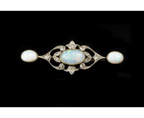 AN OPAL AND DIAMOND PANEL BROOCH, centred with a trio of oval cabochon opals in millegrain collet settings, spaced by a pierc