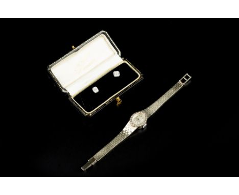 A LADY'S DIAMOND SET BRACELET WATCH, the oval silvered dial with baton markers, bordered by a single-cut diamond set bezel, t