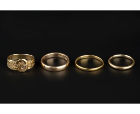 A COLLECTION OF RINGS, comprising a 9ct gold buckle ring, with scrolled decoration, a 22ct gold wedding band, and two 9ct gol