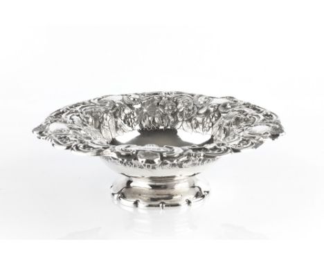 A MID VICTORIAN SILVER PEDESTAL BOWL, the borders chased and embossed with flowers and fruiting vine, and with lattice pierce