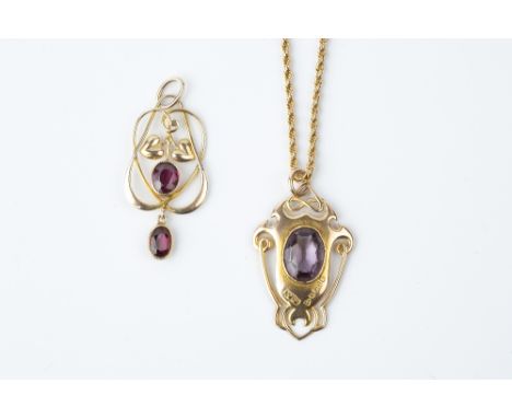 AN ARTS AND CRAFTS GARNET PENDANT BY MURRLE BENNETT &amp; CO, the sinuous openwork panel with foliate accents, centred with a