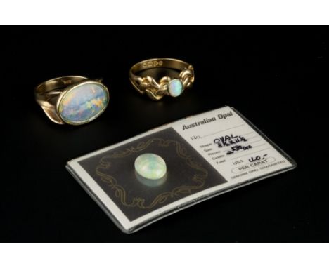 AN OPAL SINGLE STONE RING, the oval cabochon opal in collet setting, to a fancy 18ct gold mount, together with an opal triple