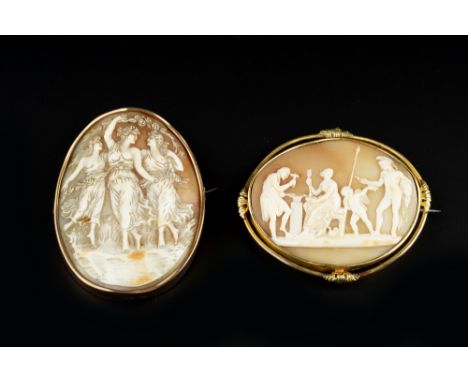 TWO OVAL SHELL CAMEO BROOCHES, the first carved to depict Vulcan's Forge, to a foliate decorated mount, the second carved to 