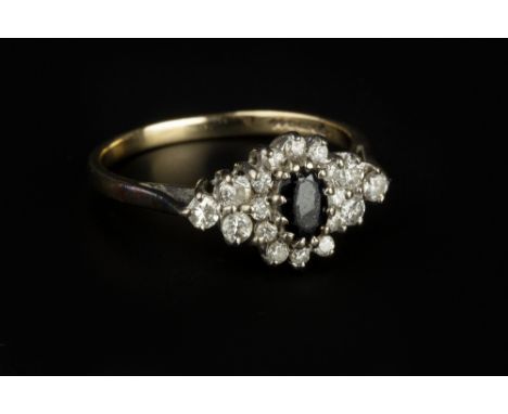 A SAPPHIRE AND DIAMOND CLUSTER RING, the oval mixed-cut sapphire claw set within a cluster of graduated round brilliant-cut d