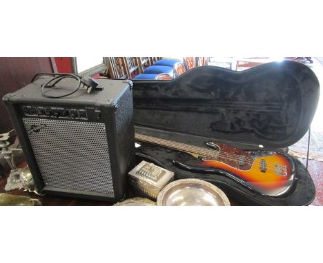 Cased bass guitar by Vintage with amplifier