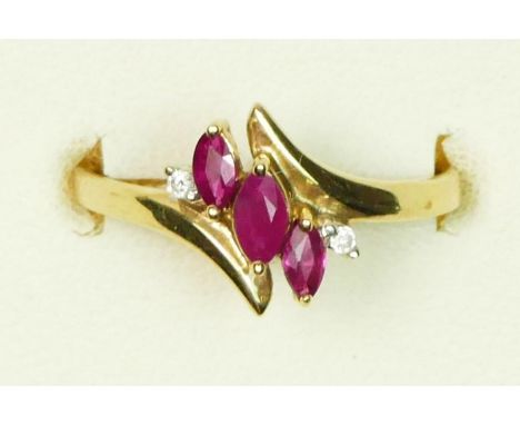 A 9ct gold three stone ruby and brilliant cut diamond dress ring, N, 1.8gm 