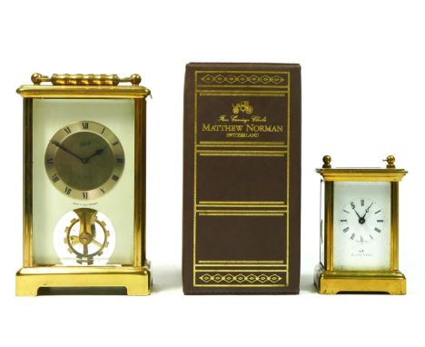 A miniature brass cased carriage clock, retailed by Mathew Norman, white enamelled dial with roman numerals, having 8 day Swi