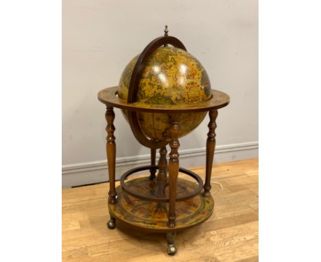 A drinks trolley in the form of a globe on base, hinged top opens to reveal a internally fitted glass and bottle holder, with