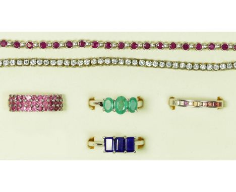 A silver and ruby line bracelet, a white stone example, both 18.5cm and four silver and gemset rings 