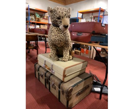 An early 20th century wood bound traveling trunk, together with a mid 20th century suitcase and a large plush toy of a leopar