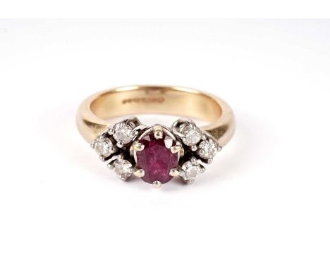 A ruby and diamond ring, the central faceted oval ruby flanked by trios of brilliant round cut diamonds, in 18ct yellow gold,