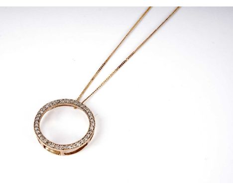 A diamond pendant, of circular form, set with round brilliant cut diamonds, in 9ct yellow gold, 21mm diameter, on 9ct gold ch