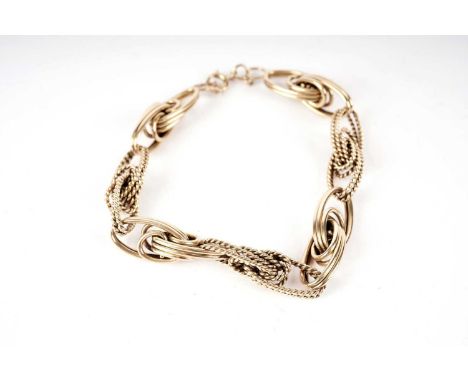 An 18ct yellow gold fancy link chain bracelet, formed of interlocking oval and rope-twist oval links, 20cms long, 31.3g gross