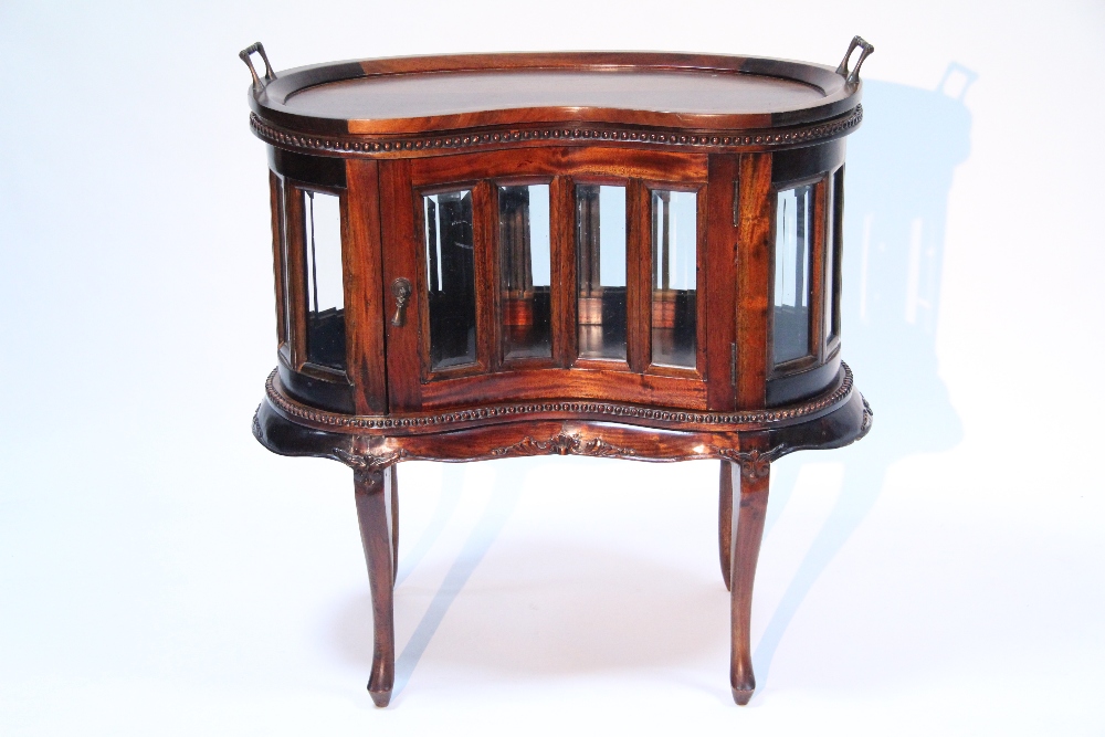 A mahogany kidneyshaped drinks with removable tray top, with